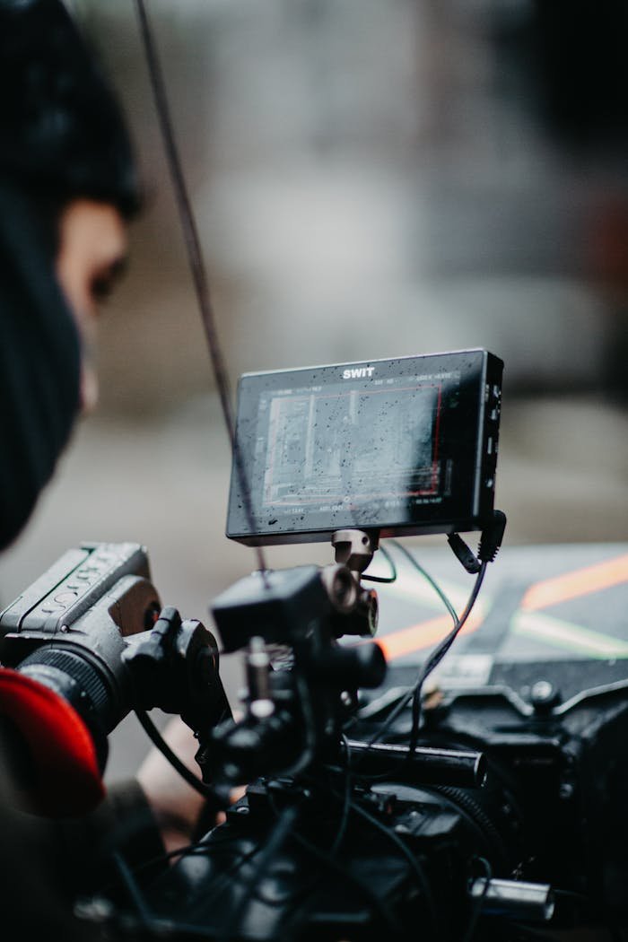 gallery-05 A professional cameraman operates advanced filming equipment in an indoor setting.